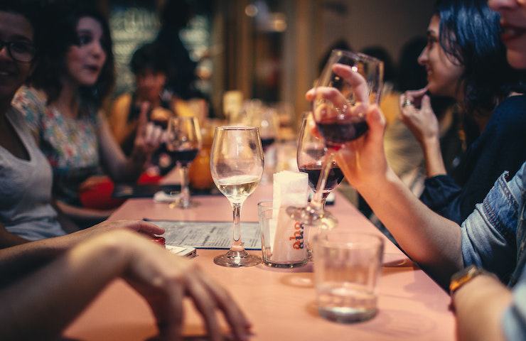 Amici che banchettano a tavola con del buon vino